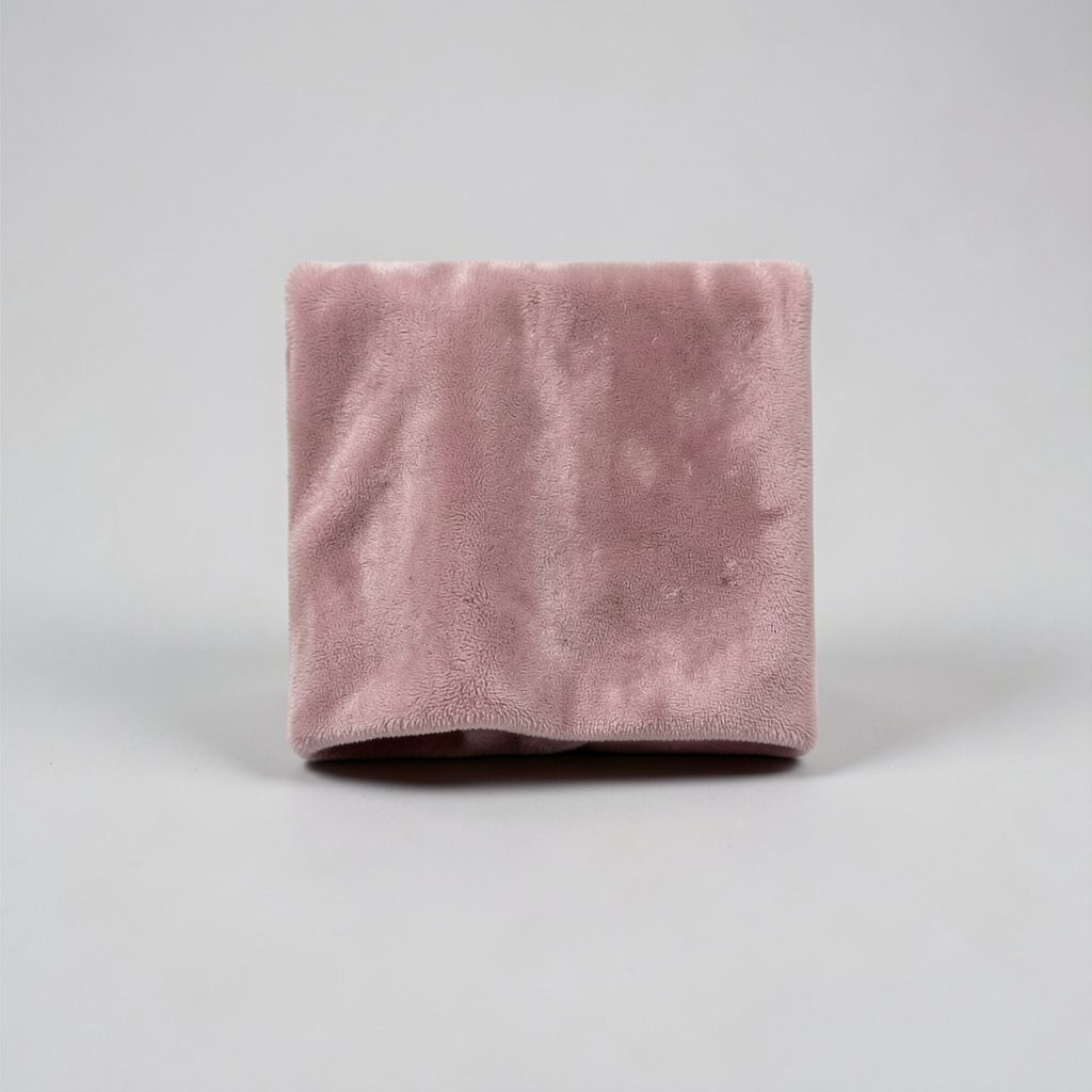 Small square photo of a velvet curtain edge in muted rose and shadow.